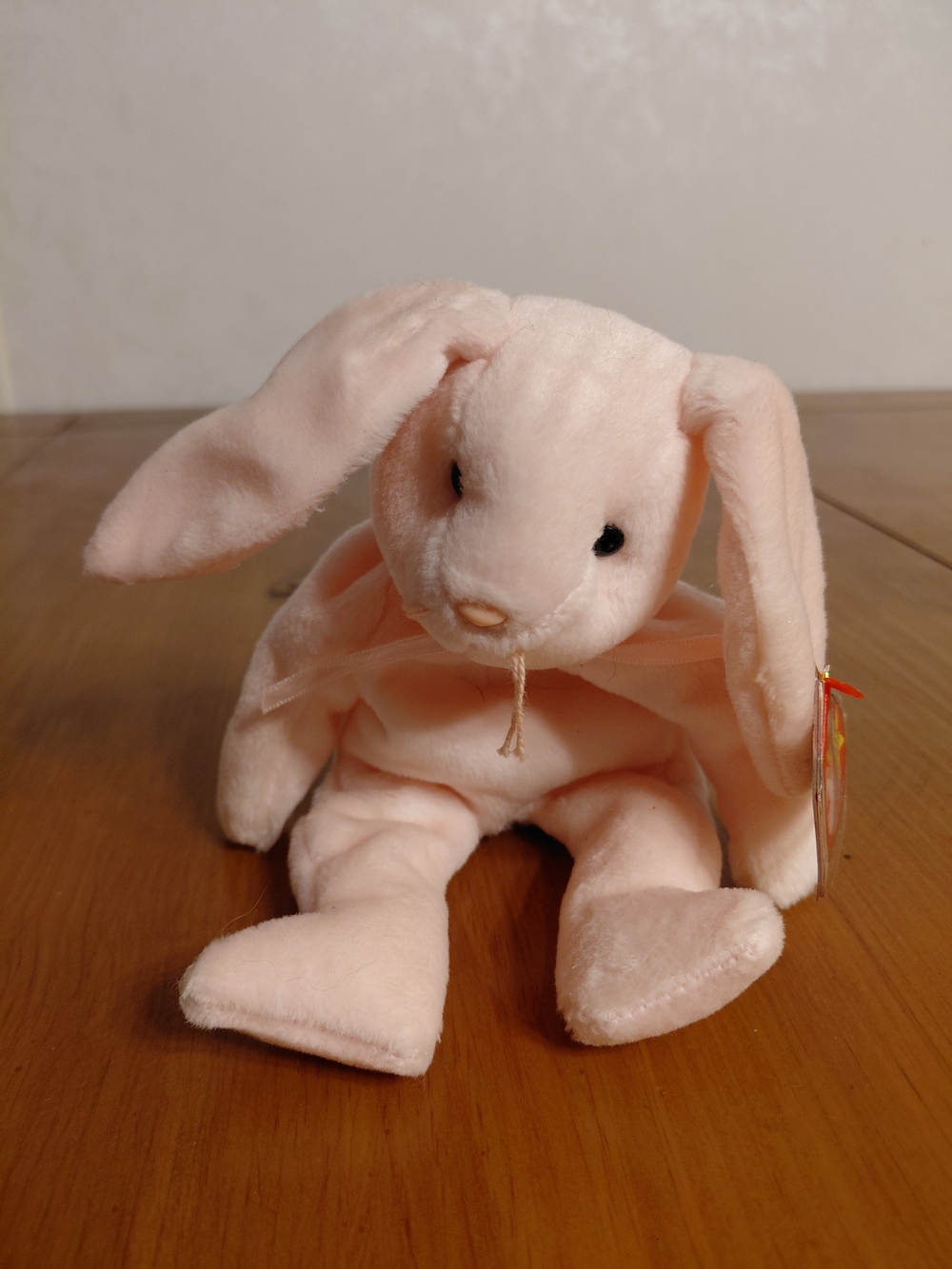 Ty Beanie Baby Hoppity the Bunny, a plush toy with pale pink fur, black button